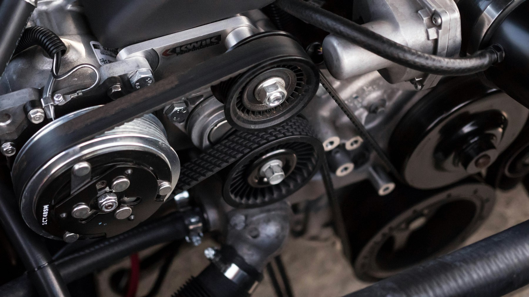 Serpentine belt and pulleys on an engine in the shop.