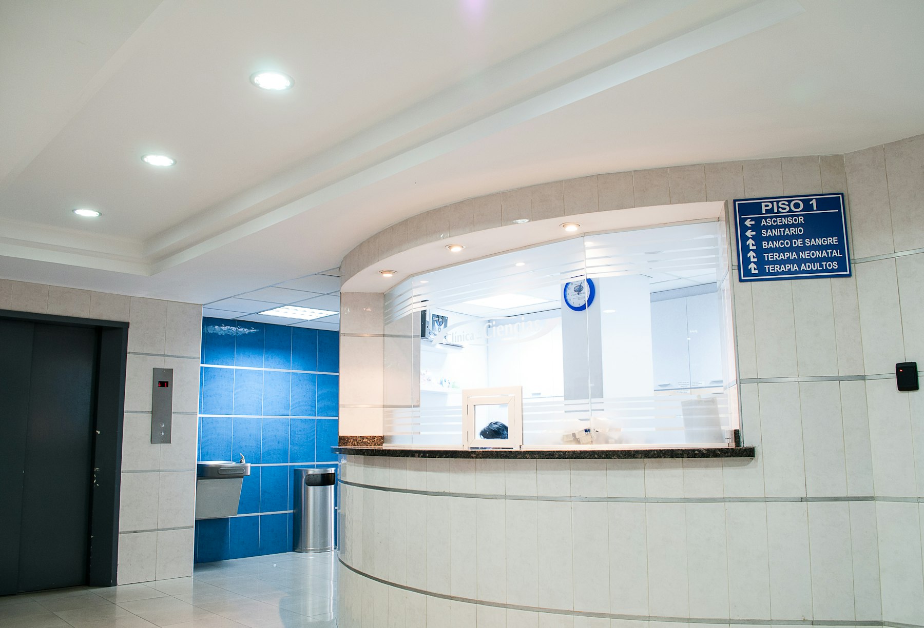 Bright clinic reception desk with soft daylight.