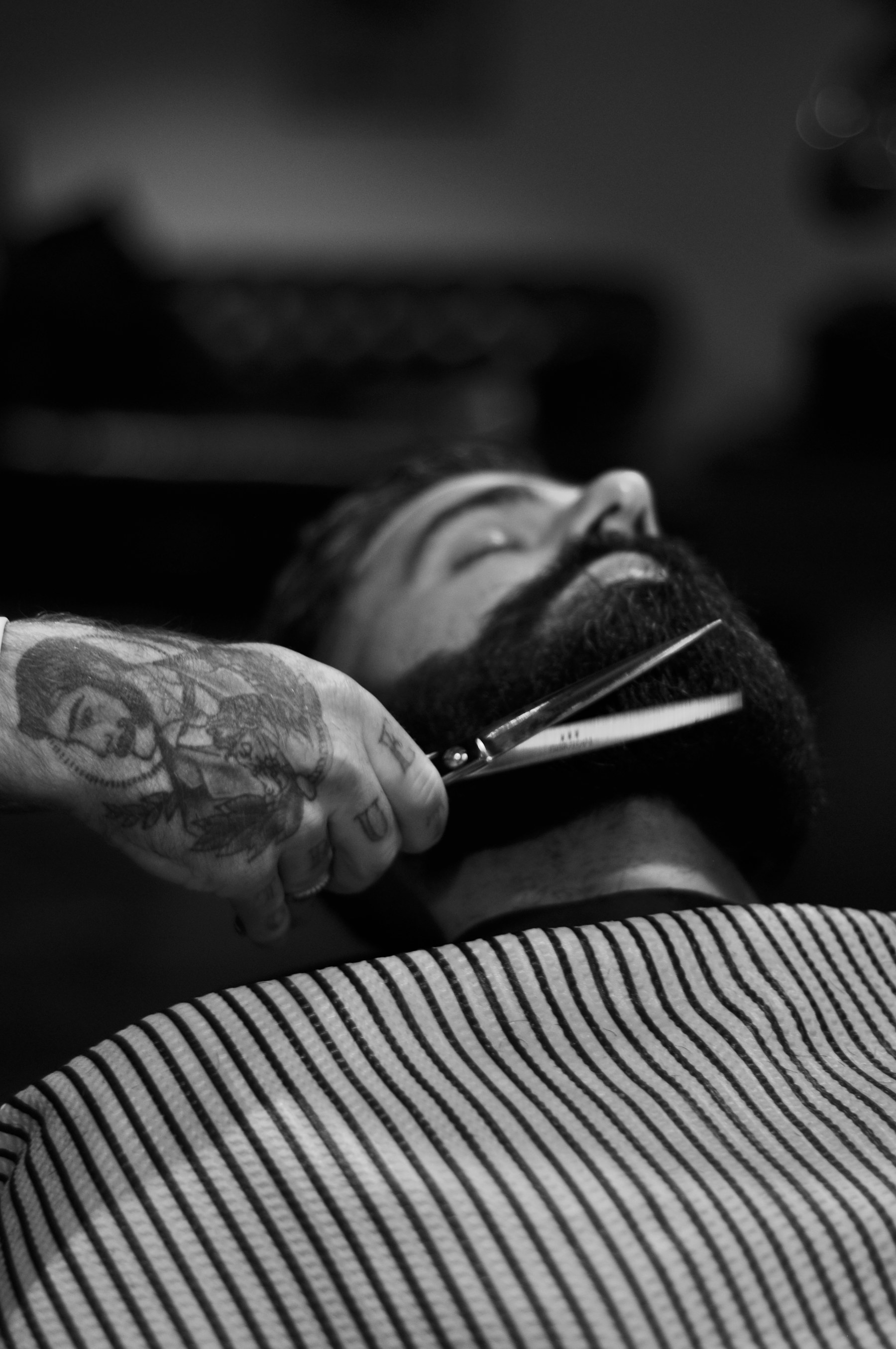 Scissors at a beard, in black and white.